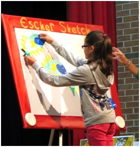 A student creates slide symmetry using fish magnets on the “Escher Sketch.”