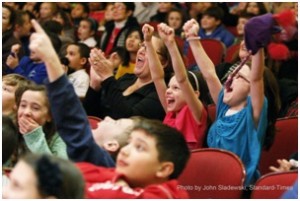 Photo courtesy of John Sladewski/Standard-Times. Students react during the 2014 Young People’s Con-certs, “The Agents of the S.D.A.”