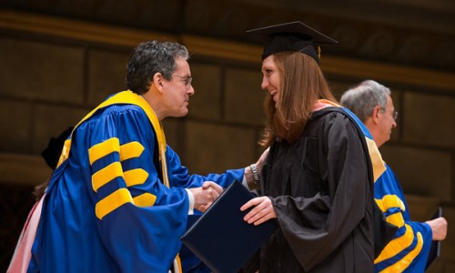 Eastman Students' Association President Molly  O'Roark shakes hands with ESM dean Doug Lowry. // University of Rochester Eastman School of Music commencement  ceremony in Kodak Hall at Eastman Theatre May 19, 2013. // photo by J. Adam Fenster / University of Rochester