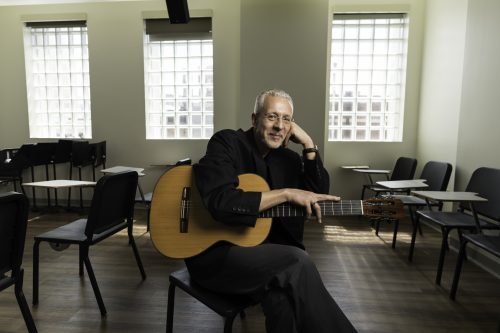 Petar Kodzas with guitar in classrroom photo