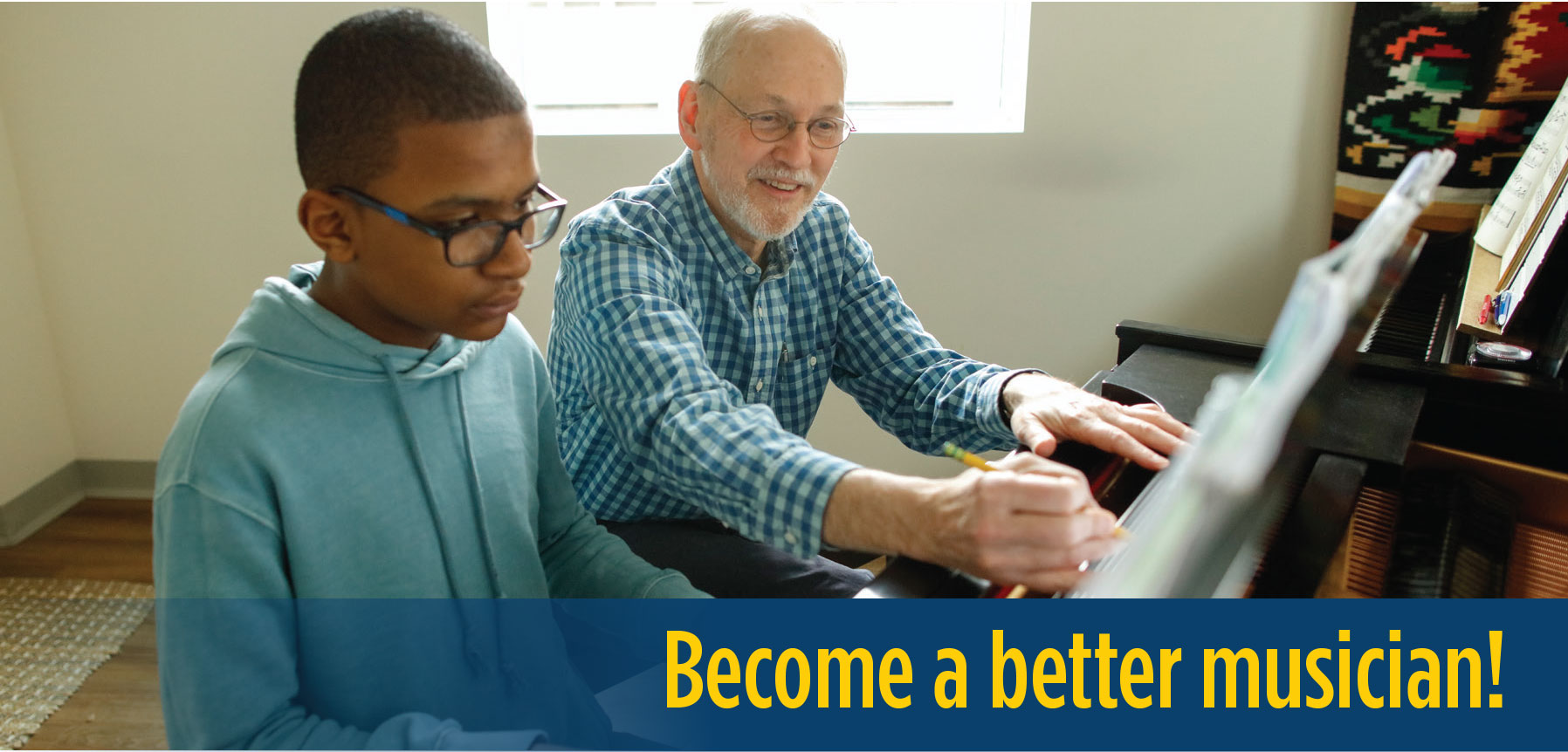 A piano teacher works with an ECMS diploma student in an individual lesson