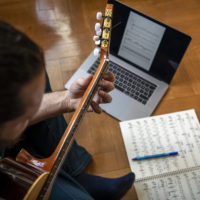 Guitarist composing at home
