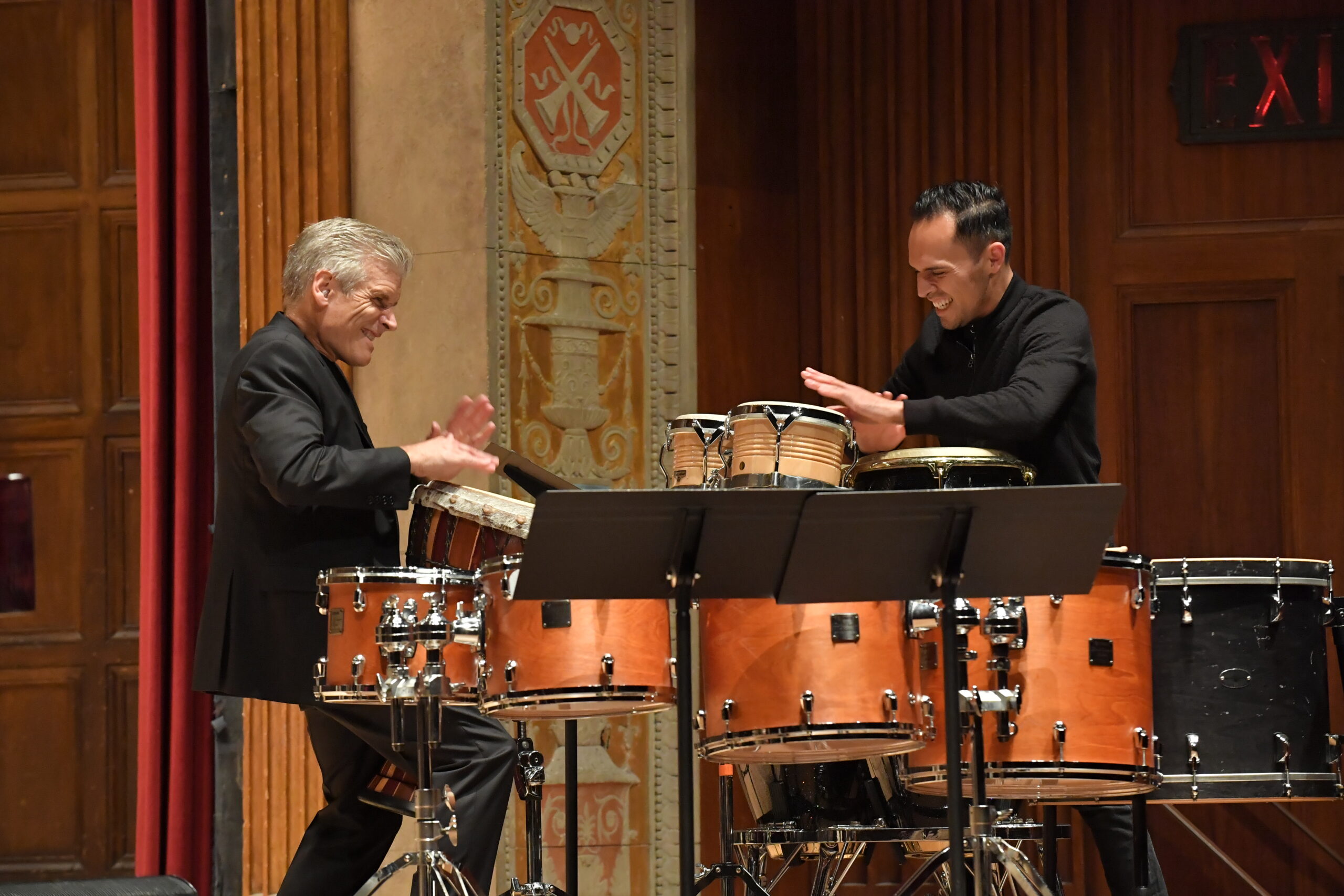 Michael Burrit and Ivan Trevino performing with percussion instruments on stage at Kilbourn Hall