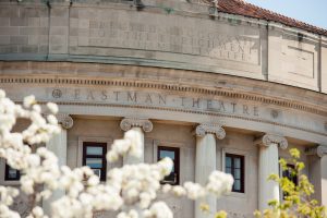 Flowering trees frame the facade of University of Rochester's Eastman Theatre