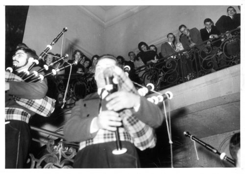 Members of the Eastman Philharmonia look over the railing at a bagpipers’ band that greeted them with music at a banquet in Rennes, France, December 6th, 1961