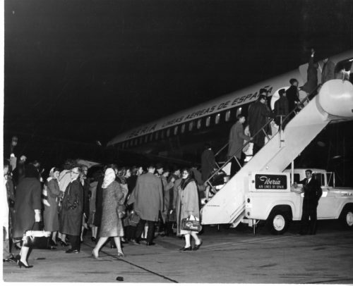 Members of the Eastman Philharmonia boarding their chartered plane at Idlewild Airport to begin their three-month tour. Photos by Louis Ouzer.