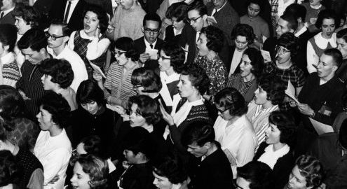 Overhead view of a crowd of students and faculty singing in Eastman’s Main Hall.