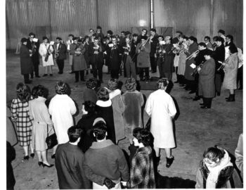 A brass band comprised of Eastman School students was on hand at Niagara Falls Airport to welcome the members of the Eastman Philharmonia home.