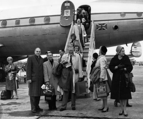 ESPA 8x10 6-37 Members of the Eastman Philharmonia, accompanied by their two conductors and chaperones, are here seen alighting from their jet on arrival at Lisbon.