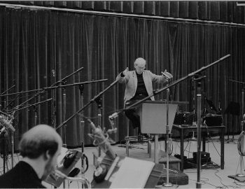 Rayburn Wright, Eastman Jazz Ensemble director, conducting members of the Eastman Jazz Ensemble in Room 120 (today known as the Ray Wright Room) on February 27th, 1983 during the recording session for the French-Canadian film Bonheur d’occasion. Louis Ouzer Archive