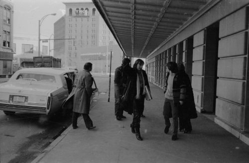 The production team for the film Bonheur d’occasion arriving at the Eastman School on the morning of February 27th, 1983, day of the Eastman Jazz Ensemble recording session. At the left-hand edge of the photos, indications of the demolition work taking place on Gibbs Street can be seen. In the distance is the old YMCA building that would itself soon be demolished. Louis Ouzer Archive