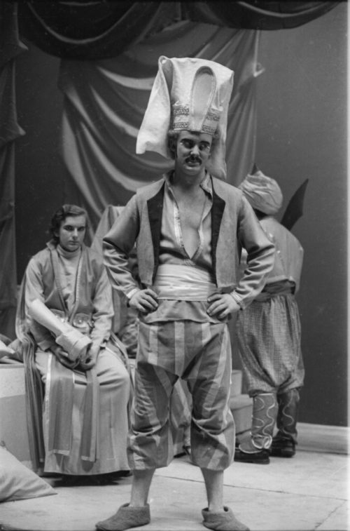 R1167-19 Members of the cast in repose during dress rehearsal.