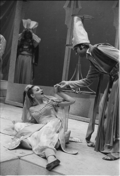 R1167-23 Members of the cast in repose during dress rehearsal.