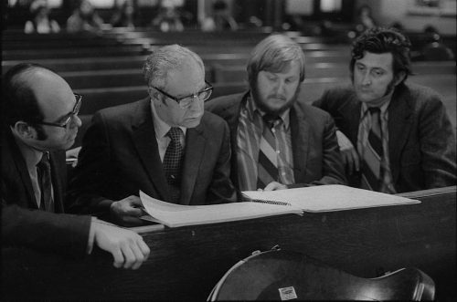During a rehearsal in Lake Avenue Baptist Church, Eastman School composers Samuel Adler, Wayne Barlow, and Joseph Schwantner peruse the score of the Concerto for Organ and Orchestra, joined (at right) by local music critic Ted Price.