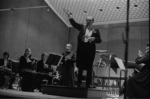 Eastman Philharmonia concert that featured the premiere of Krzystof Penderecki’s Partita for Harpsichord and Orchestra. At the conclusion of the Partita, Maestro Hendl invites the composer to the stage for bows. In the last shot, the composer, the soloist, and the conductor all join hands to acknowledge the applause.