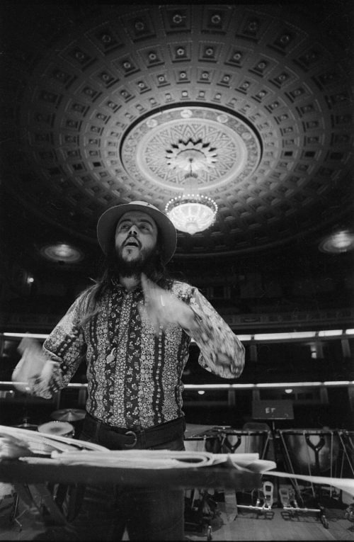 Chuck Mangione on the podium in the Eastman Theater, captured by Louis Ouzer during a rehearsal. This striking sequence is emblematic of Mr. Ouzer’s penchant of capturing conductors on the podium with the visually imposing chandelier in the background.
