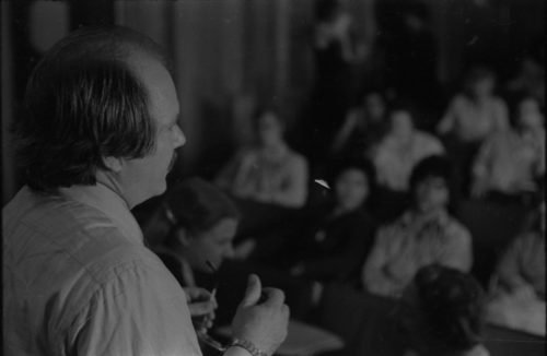 John Perry addressing listeners in Howard Hanson Hall.