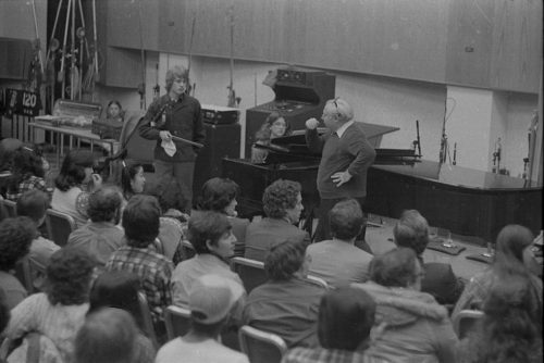 Violinist Isaac Stern working with an Eastman violin student during a master class in Room 120