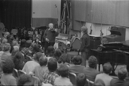 Violinist Isaac Stern working with an Eastman violin student during a master class in Room 120