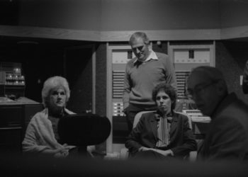 Principals gather in the control room to hear playbacks. Variously seen in these shots are conductor Donald Neuen, producer Ray Wright, recording engineer Ros Ritchie, harpsichordist Arthur Haas, and several of the vocal soloists.