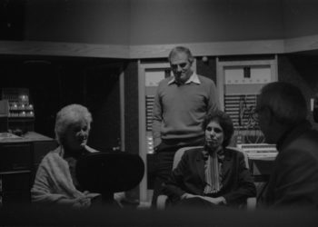 Principals gather in the control room to hear playbacks. Variously seen in these shots are conductor Donald Neuen, producer Ray Wright, recording engineer Ros Ritchie, harpsichordist Arthur Haas, and several of the vocal soloists.