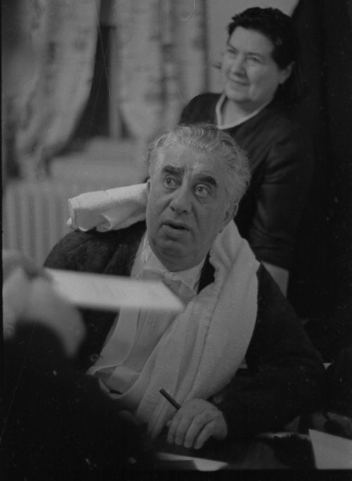 Guest conductor Aram Khachaturian signing autographs after the Eastman Philharmonia concert, March 11th, 1968; his wife, composer Nina Makarova, stands behind him.