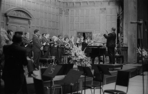 Members of the Eastman Chorale on-stage in Kilbourn Hall, conducted by Professor Milford Fargo. In the first two shots, baritone Joseph Bias (not holding a score) is the soloist.