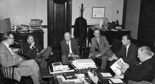 Howard Hanson sits in his office with 5 members of the composition faculty.