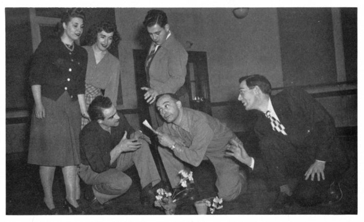 The Score 1948 page 61 photo Treash coaching students Director Treash (at right) coaching student performers in rehearsal for The Marriage of Figaro, spring 1948. Photo published in The Score 1948.