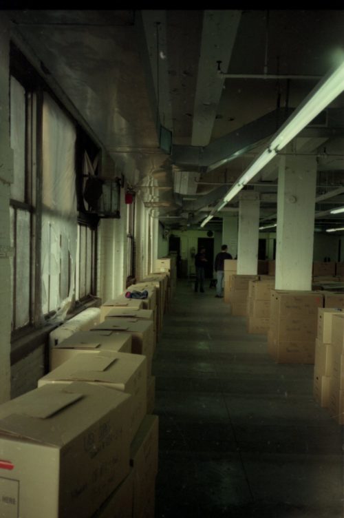 image 19 team members Brodsky, Coppen and Quinn are seen among the lines of shipping crates