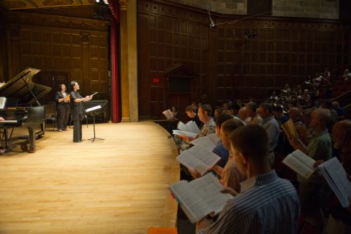 Students singing with conductor