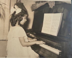 Gloria Mikialian '45E performing piano as a child.
