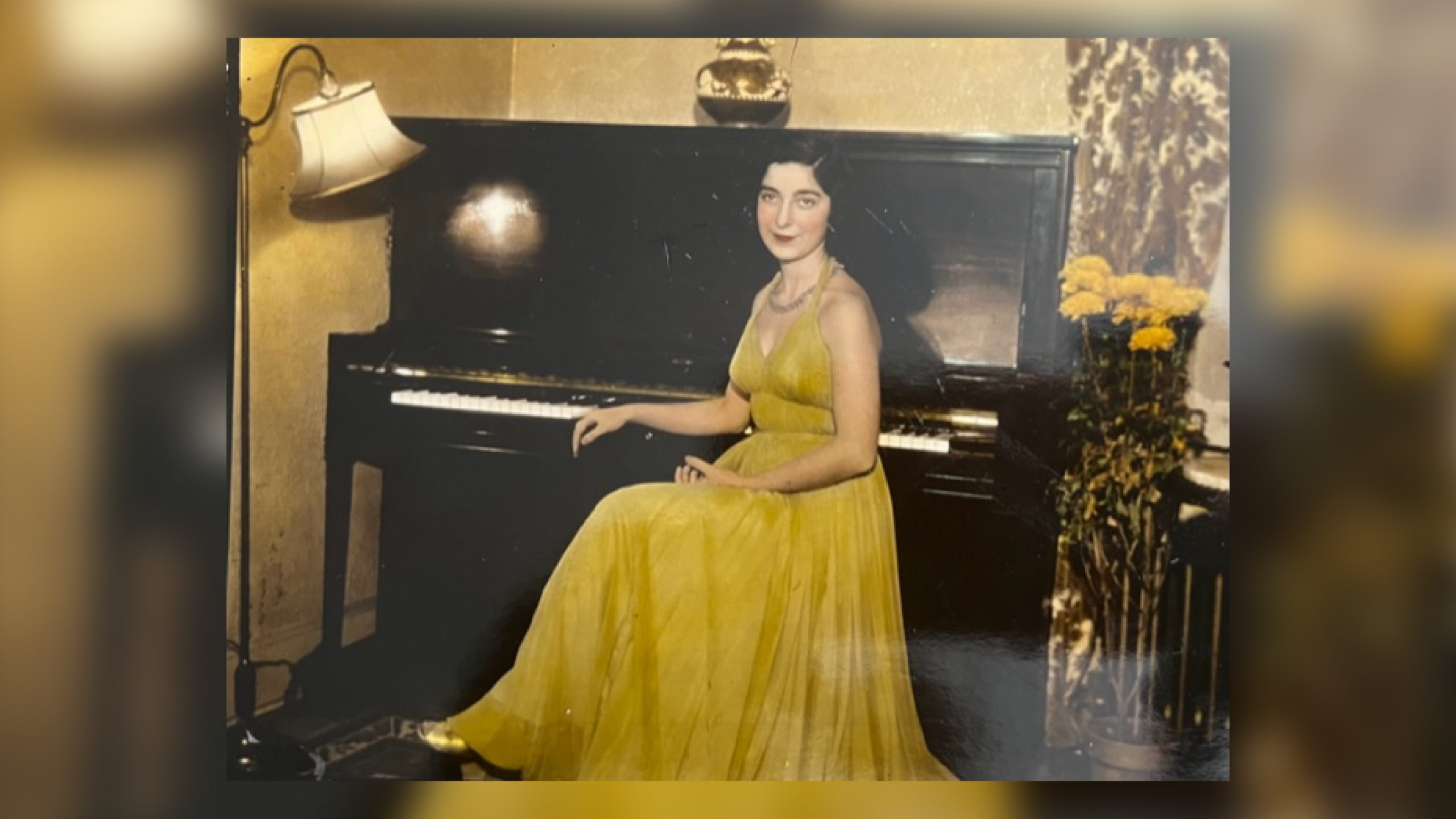 Alumna Gloria Mikialian '45E in a yellow dress at the piano. Date unknown.