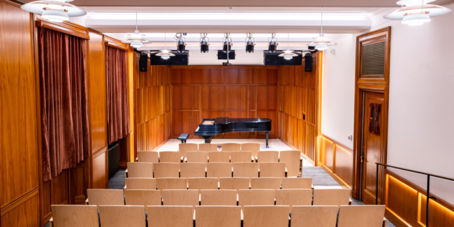 Newly renovated Howard Hanson Hall, from the audience, looking at the stage and Steinway piano.