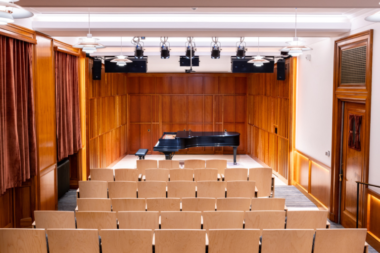 Newly renovated Howard Hanson Hall, from the audience, looking at the stage and Steinway piano.