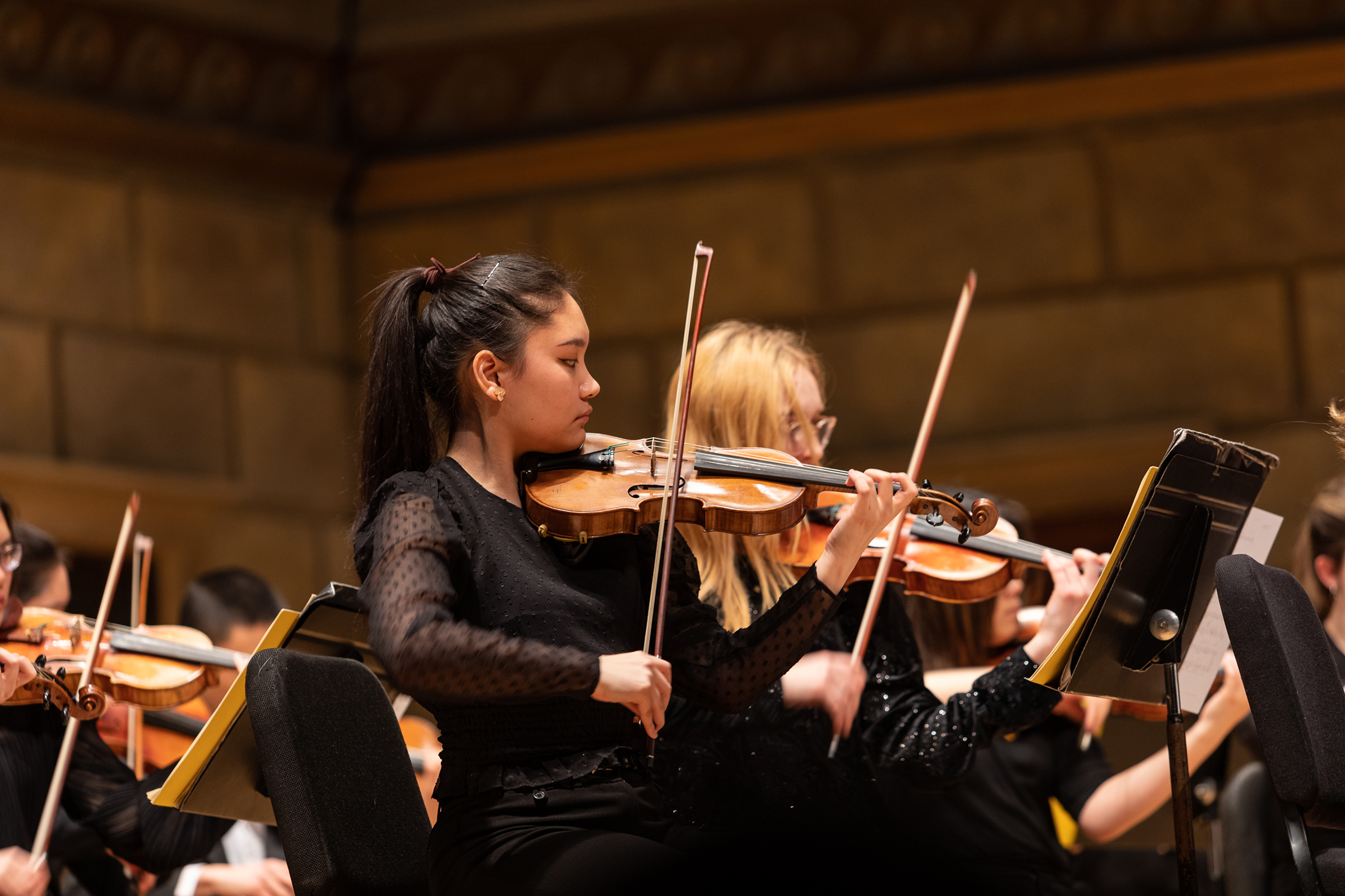 Image of two violinists performing in Kodak Hall Image of two violinists performing in Kodak Hall