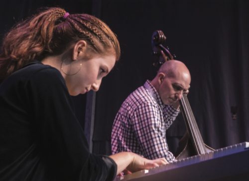 Jeff Campbell performing with a student