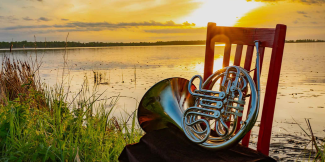 LAMF-news Image of horn on chair with sunset over water behind