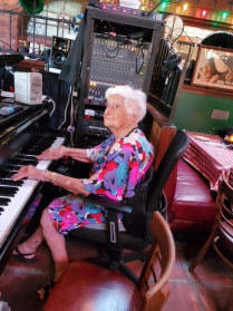 Alumna Gloria Mikialian '45E playing the piano at her 100th birthday party.