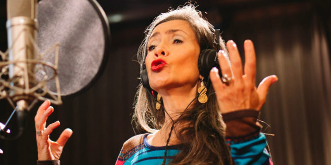 Patricia Caideco singin into microphone
