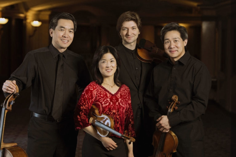 Ying Quartet stand with instruments in Eastman Theatre lobby