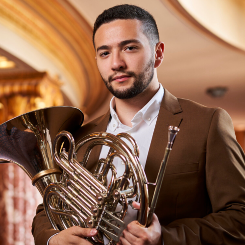 Nathaniel Silberschlag pictured holding a French horn