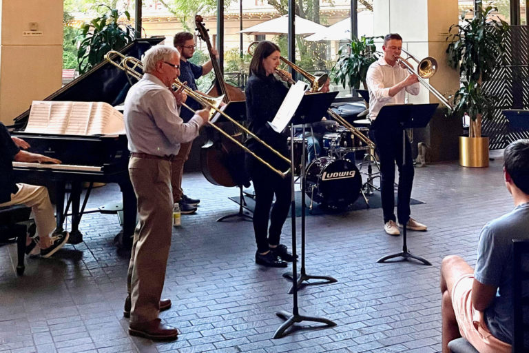 trombone players in atrium